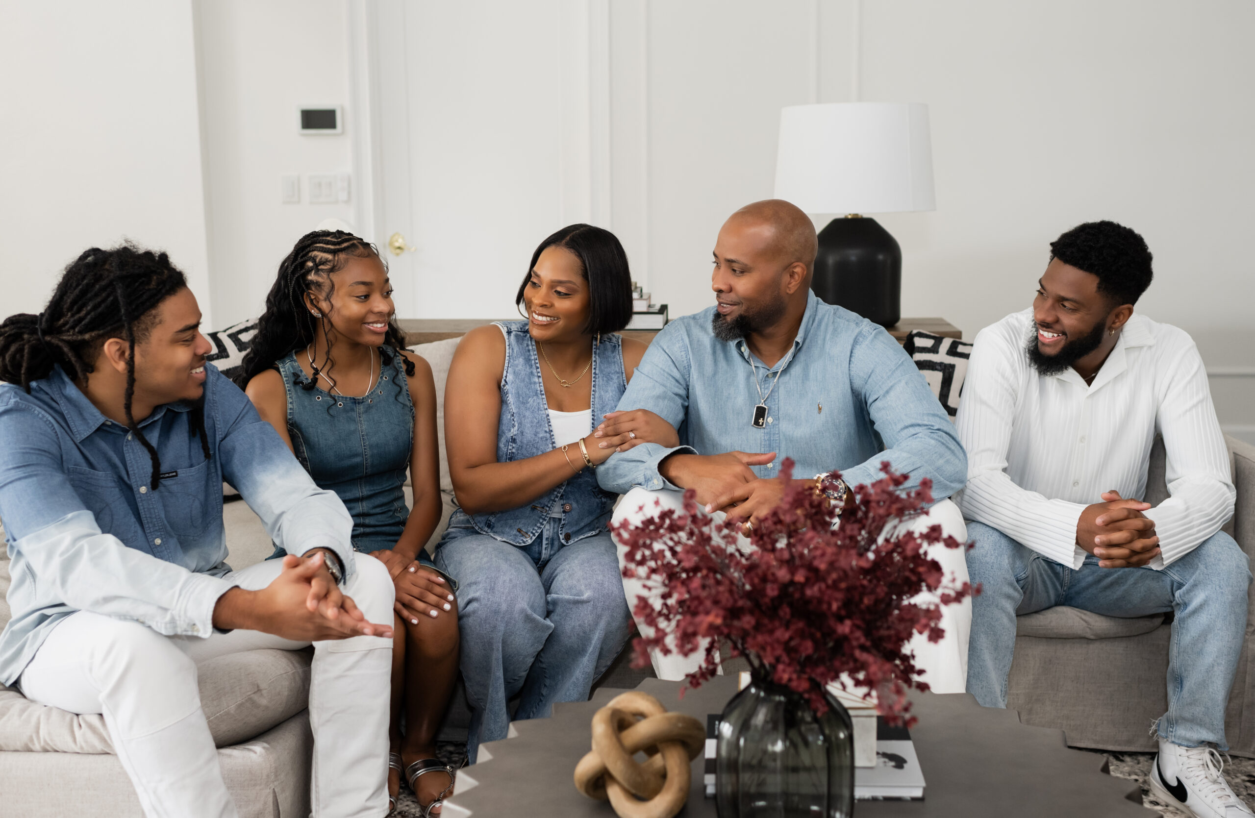 Image of the Walls family sitting on a couch in an informal setting.